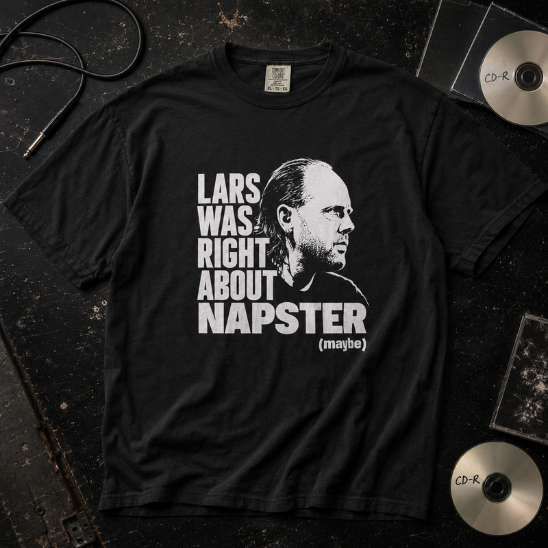 A black graphic t-shirt laid flat on a dark textured surface, featuring a white print of a man's profile and the text 'LARS WAS RIGHT ABOUT NAPSTER (maybe)'. CD cases and a CD are partially visible around the shirt as styling props.